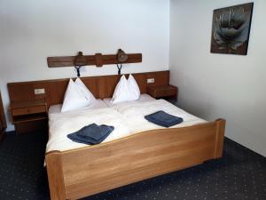 a bedroom with a bed with two blue towels on it at Landgasthof Hotel Zehenthof in Pfarrwerfen