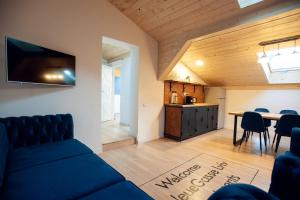 a living room with a couch and a table at Neue Gasse Lviv apartments in Lviv