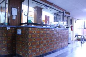 a restaurant with a tile counter in a room at Hotel Plaza Aleman in Le&oacute;n