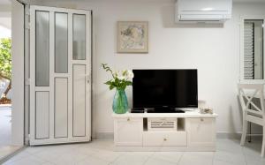 a living room with a tv and a white door at Holiday Home Belina in Stari Grad