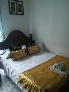 a bed with two pillows on top of it at Hotel Cristo Rei in Porto
