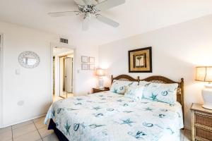a bedroom with a bed and a ceiling fan at Saida Tower I in South Padre Island