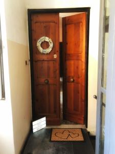 a wooden door with areath on it in a hallway at CA’ DEL MARE in Bogliasco