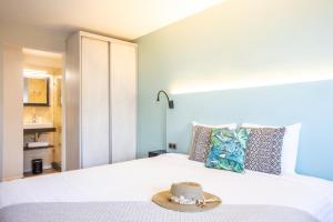 a bedroom with a bed with a hat on it at Centr'Hotel in Marigot