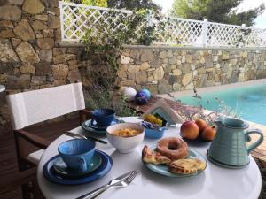 a table with plates of food and coffee on it at Stile libero b&b in Lacona