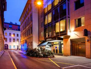 an empty street in a city at night at Ambra Hotel in Budapest