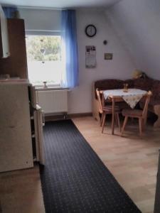 a kitchen and dining room with a table and a window at Ferienwohnung Heidi in Selb