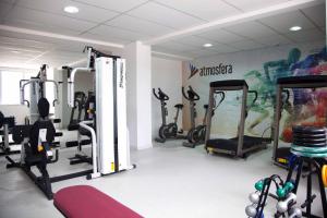 a gym with several tread machines in a room at Atmosfera Hotel in Feira de Santana