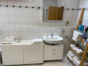 a white bathroom with a sink and a mirror at Privatquartier im Ortskern von Westerstede in Westerstede