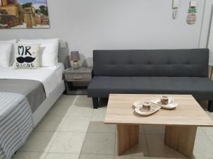 a bedroom with a bed and a coffee table at Ierapetra Suites & Studios in Ierapetra