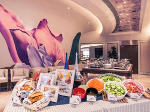 a buffet of food on a table in a restaurant at Mercure Hangzhou West Lake in Hangzhou +41 photos