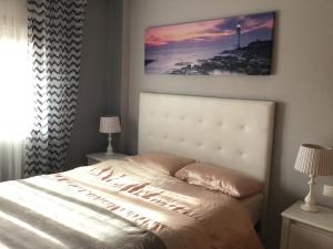 a bedroom with a bed with a picture on the wall at Apartamento LAVANDA , Costamarina, Cabo Roig in Orihuela Costa +32 photos