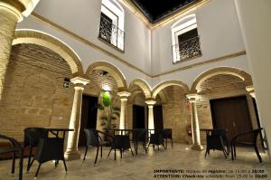 a room with tables and chairs in a building at Patios del Orfebre in Córdoba