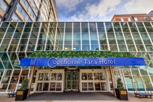a blue building with a sign on the front of it at Copthorne Tara Hotel London Kensington in London