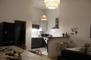 a living room with a table and a kitchen at Appartement vue imprenable sur la Loire !!! in Saumur