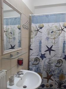 a bathroom with a sink and a shower curtain at Gerapetros 82 in Ierapetra +27 photos