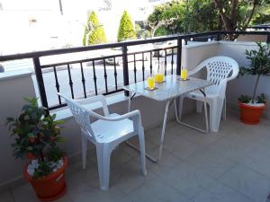 a table and chairs on a balcony with drinks on it at Ierapetra Suites & Studios in Ierapetra