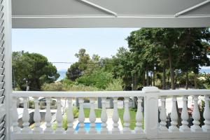 a white balcony with a view of the ocean at Divine Villa in Toroni