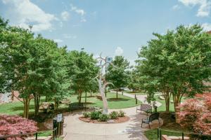 a park with benches and trees in a park at The Esquire Hotel Downtown Gastonia, Ascend Hotel Collection in Gastonia