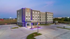 a large building with purple lights in a parking lot at Comfort Suites DeSoto Dallas South in DeSoto