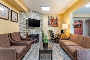 a living room with two couches and a fireplace at Quality Inn & Suites Mason City in Mason City
