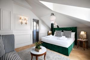 a bedroom with a green bed and a chair at Matilde Boutique Hotel in Milan