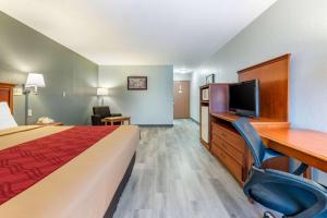 a hotel room with a bed and a desk and a television at Econo Lodge Lebanon in Lebanon
