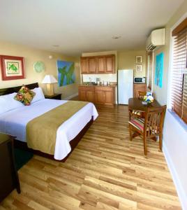 a hotel room with a bed and a kitchen at Harborside Motel & Marina in Key West