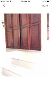 a wooden door on a window in a room at Terrazas del Caribe, Boca Chica. in Boca Chica