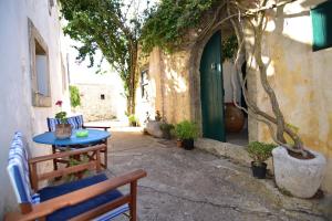 a patio with two benches and a table and a tree at Axion Studios in Aroniadika