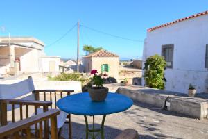 a blue table with a potted plant on a patio at Axion Studios in Aroniadika