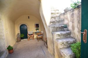 an alleyway with a table and chairs in a building at Axion Studios in Aroniadika