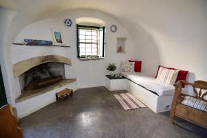 a living room with a couch and a fireplace at Axion Studios in Aroniadika