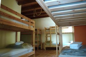 a room with two bunk beds and a window at Albergue Usandi Auto Check-in in Ziortza-Bolibar