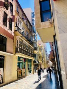 a group of people walking down a city street at Casa Poeta Pelayo in Cartagena +94 photos