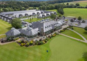 an aerial view of a large house with a green lawn at The Lodges at Kilkea Castle in Kilkea