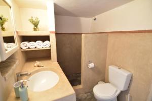 a bathroom with a white toilet and a sink at Axion Studios in Aroniadika