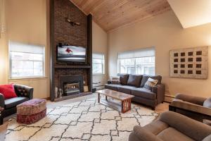 a living room with couches and a fireplace at 9 Vail Road Vail Village 2 to 4 Bedrooms by Vail Realty in Vail