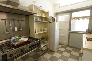 a kitchen with a stove and a refrigerator at Home sweet home in Breskens