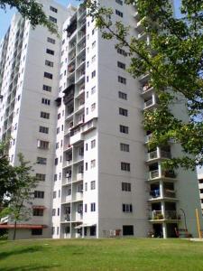 a tall white apartment building with a grass field at Atocha Homestay - Sungai Besi@KL in Kuala Lumpur