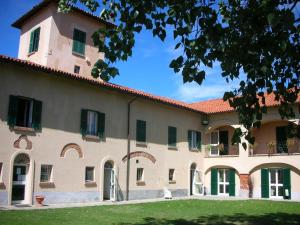 um grande edifício com um relvado verde em frente em Agriturismo Tenuta la Marchesa em Novi Ligure