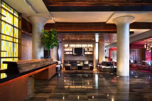 a lobby with couches and a bar in a hotel at Ink 48 Hotel in New York