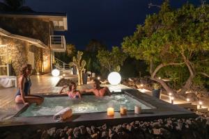 a group of people sitting in a hot tub at night at Finch Bay Galapagos Hotel in Puerto Ayora +51 photos