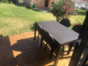 a black table and chairs on a patio at La Casita de Laura in Bolonia