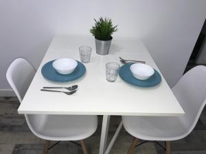 a white table with blue plates and napkins on it at La Casita de Laura in Bolonia