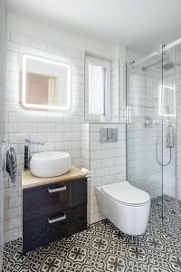 a bathroom with a sink and a toilet and a shower at Tiny Vacation in Písek