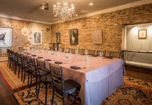 a long table in a room with a brick wall at The Vendue, Downtown Art Hotel in Charleston