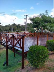 a wooden bench sitting on top of a wooden bridge at Apartamento Emaús in Parnamirim