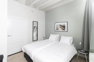 Ένα ή περισσότερα κρεβάτια σε δωμάτιο στο Franekerpoort hotel appartementen