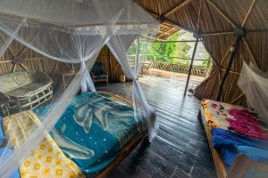 a bedroom with two beds in a tent at Byoona Amagara at Lake Bunyonyi in Kabale